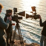 Scenic coastal filming location in Portugal with film crew setting up equipment